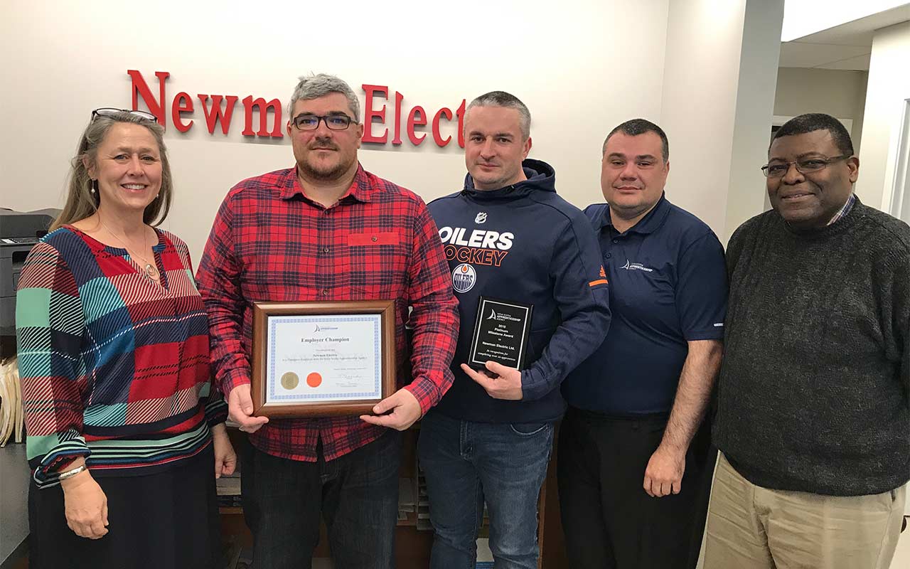 Five employees of Newman Electric gather for a photo with their Employer Champion award