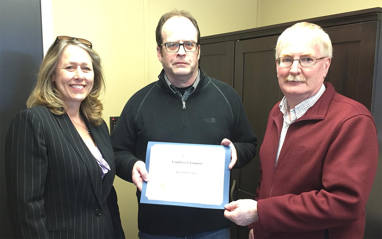 Employees of Martin Marietta gather around their Employer Champion award