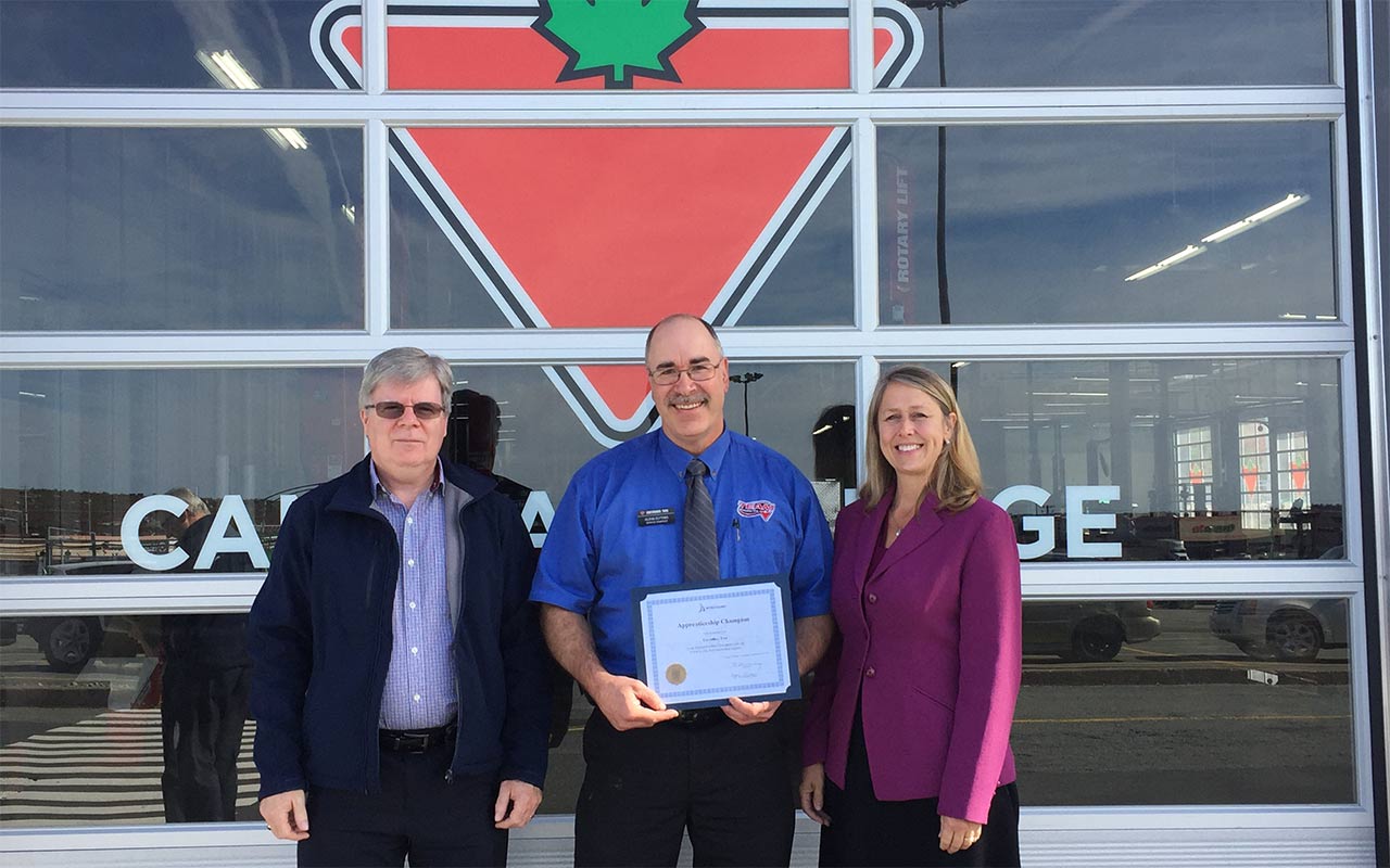 Employees of Bayers Lake Business Park gather around their Employer Champion award