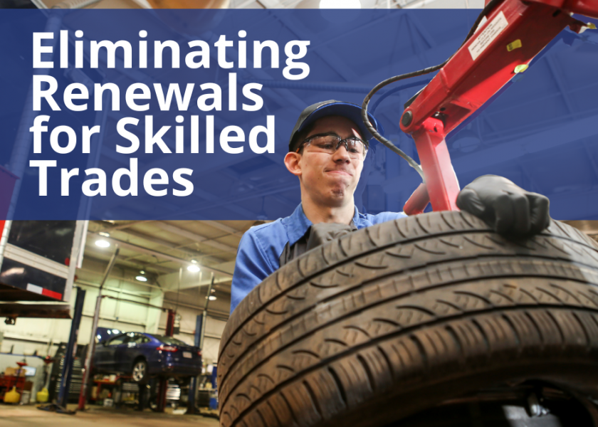 Male apprentice lifting tire.