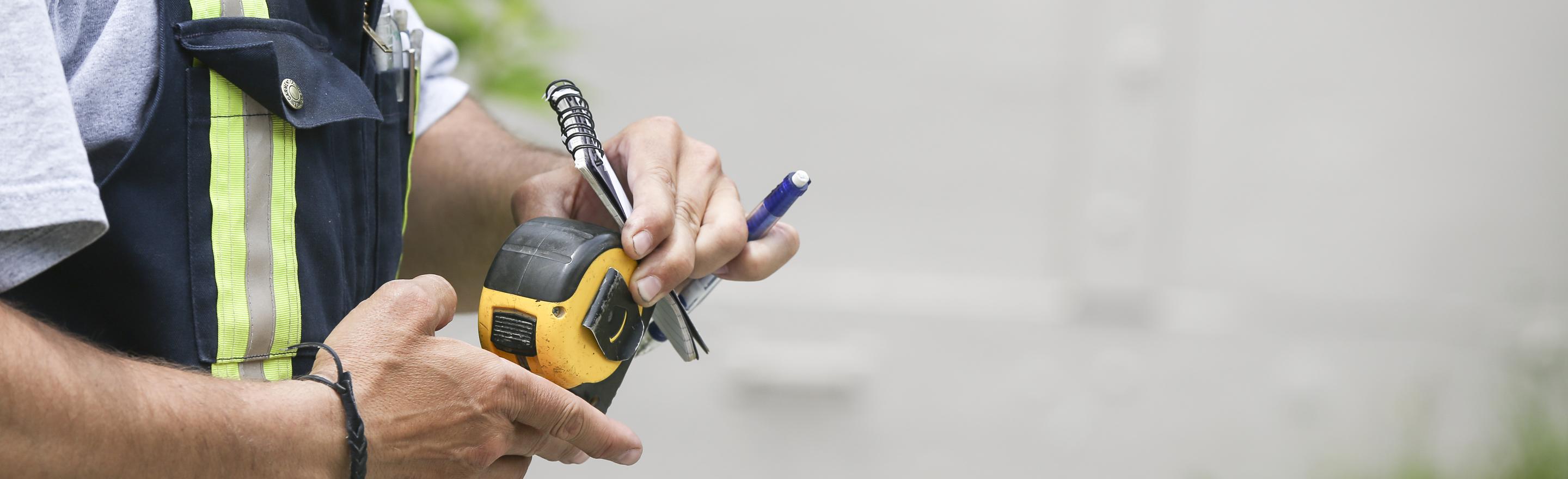 Man with measuring tape.