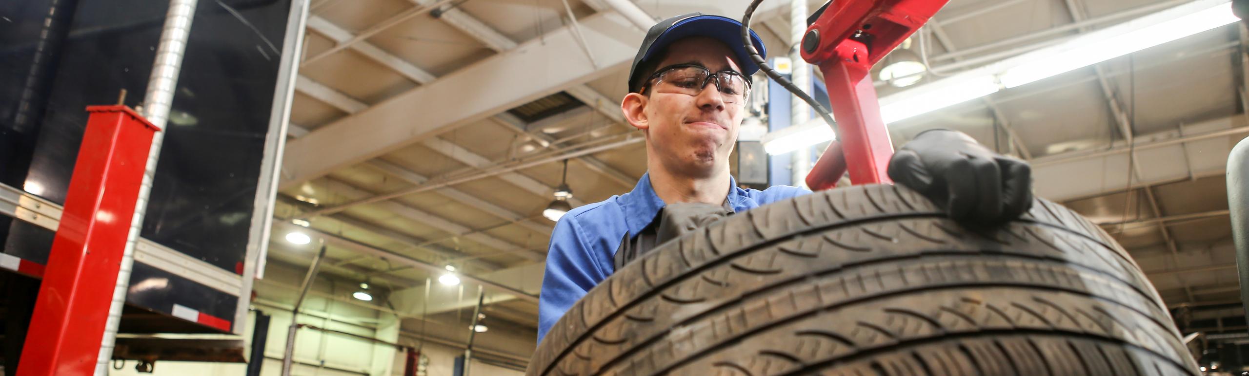 apprentice lifting tire